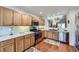 Bright kitchen featuring stainless steel appliances, light wood cabinets, and easy access to other living spaces at 2556 E 131St Pl, Thornton, CO 80241