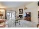 Comfortable living area features a fireplace, plush furnishings, and access to an enclosed sunroom at 2556 E 131St Pl, Thornton, CO 80241