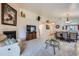 Spacious living area with fireplace, comfortable seating, and open layout to the adjacent dining room at 2556 E 131St Pl, Thornton, CO 80241