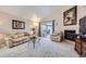 Bright and airy living room with cozy fireplace, plush seating, and sliding glass doors to the sunroom at 2556 E 131St Pl, Thornton, CO 80241