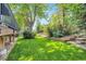 Expansive backyard featuring lush lawn, mature trees, and thoughtfully designed terraced landscaping at 5050 W 102Nd Ave, Westminster, CO 80031