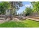 Backyard featuring mature trees, treehouse, trampoline, and manicured landscape, offering privacy and outdoor fun at 5050 W 102Nd Ave, Westminster, CO 80031