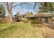 A verdant backyard featuring mature trees, a covered patio, and a spacious deck, ideal for relaxation at 5050 W 102Nd Ave, Westminster, CO 80031