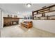 Basement living area features a cozy brick fireplace with mantle and open shelving at 5050 W 102Nd Ave, Westminster, CO 80031