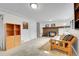 Cozy basement living area enhanced by a traditional brick fireplace and adjacent shelving at 5050 W 102Nd Ave, Westminster, CO 80031