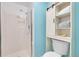 Bathroom with tile shower and storage cabinet with open shelving at 5050 W 102Nd Ave, Westminster, CO 80031