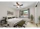 Bedroom featuring ceiling fan, neutral walls, and large window for natural light at 5050 W 102Nd Ave, Westminster, CO 80031