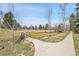 Scenic community park featuring a charming wooden bridge and winding paved pathway at 5050 W 102Nd Ave, Westminster, CO 80031