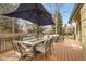 Relaxing deck with an outdoor dining table, chairs, umbrella, and comfortable lounge seating at 5050 W 102Nd Ave, Westminster, CO 80031