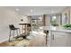 Dining area featuring bar seating, sliding glass doors to patio and neutral walls at 5050 W 102Nd Ave, Westminster, CO 80031