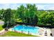 Inviting swimming pool with lounge chairs surrounded by lush greenery and trees at 5050 W 102Nd Ave, Westminster, CO 80031