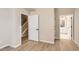 Bright, neutral bedroom with light hardwood floors, white doors, and a view into an adjacent bathroom at 9629 Browns Peak Cir, Littleton, CO 80125