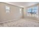 Bedroom featuring two windows with views, plush carpeting, and ample natural light at 9629 Browns Peak Cir, Littleton, CO 80125
