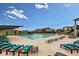 Community pool with ample lounge seating, umbrellas, and views of surrounding homes at 9629 Browns Peak Cir, Littleton, CO 80125
