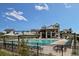 Community pool with lounge chairs and umbrellas, set against modern architecture at 9629 Browns Peak Cir, Littleton, CO 80125