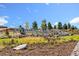 Community sign featuring the 'Sterling Ranch' name with beautiful landscaping and clear blue skies at 9629 Browns Peak Cir, Littleton, CO 80125