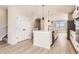 Stylish kitchen features a large center island, stainless steel appliances, and light wood flooring at 9629 Browns Peak Cir, Littleton, CO 80125