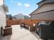Cozy backyard patio area set for relaxing, complete with wicker seating and a grill at 11650 Park South Ln, Parker, CO 80138
