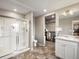 Bathroom featuring a glass-enclosed shower, tiled floor, and a sink with white cabinets at 11650 Park South Ln, Parker, CO 80138