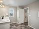 A bathroom with dual sinks, tiled floors, and neutral paint for a modern look at 11650 Park South Ln, Parker, CO 80138