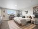 Inviting bedroom featuring a large window, computer desk, and stylish decor at 11650 Park South Ln, Parker, CO 80138