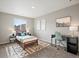 Comfortable bedroom with neutral decor, a work desk, and a patterned area rug at 11650 Park South Ln, Parker, CO 80138