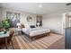 A bright bedroom features a large bed, stylish decorations, and a neutral color palette at 11650 Park South Ln, Parker, CO 80138
