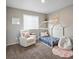 Charming bedroom with a cozy reading chair and a playful house-frame bed at 11650 Park South Ln, Parker, CO 80138