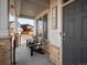 Inviting covered front porch with chairs, stone pillars, and clear home address display at 11650 Park South Ln, Parker, CO 80138