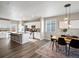 Bright kitchen with white cabinets, granite countertops, stainless steel appliances, and dining area at 11650 Park South Ln, Parker, CO 80138