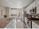 Bright kitchen features granite countertops, stainless steel appliances, and wood flooring at 11650 Park South Ln, Parker, CO 80138