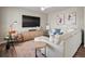 Stylish living room with a large TV, comfortable seating, and elegant decor at 11650 Park South Ln, Parker, CO 80138
