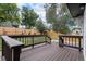 Private backyard deck with wood railings, lush greenery, and a tall wood fence for added seclusion at 19334 E Prentice Pl, Centennial, CO 80015