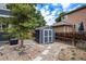 Backyard with a shed, gravel, stepping stones and lush greenery at 19334 E Prentice Pl, Centennial, CO 80015