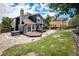 Beautiful blue home featuring a spacious wooden deck, hot tub, and a lush green lawn at 19334 E Prentice Pl, Centennial, CO 80015