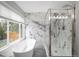 Luxurious bathroom with a free-standing tub, glass-enclosed shower, and elegant marble walls at 19334 E Prentice Pl, Centennial, CO 80015