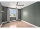 Cozy bedroom with hardwood floors, window view, and ceiling fan at 19334 E Prentice Pl, Centennial, CO 80015