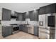 Modern kitchen with gray cabinets, stainless steel appliances, subway tile backsplash, and hardwood floors at 19334 E Prentice Pl, Centennial, CO 80015