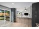Open kitchen featuring gray cabinetry, hardwood floors, bar seating, and sliding glass door to the outdoor deck at 19334 E Prentice Pl, Centennial, CO 80015