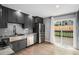 Stylish kitchen with stainless steel appliances, gray cabinets, hardwood floors, and access to the deck at 19334 E Prentice Pl, Centennial, CO 80015
