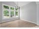 Light-filled living room featuring hardwood floors, expansive windows, and a modern chandelier at 19334 E Prentice Pl, Centennial, CO 80015