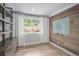 Cozy office space with wood paneled accent wall, shelving, hardwood floors, and a bright window at 19334 E Prentice Pl, Centennial, CO 80015