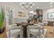 Elegant dining room with modern lighting, stylish chairs, and hardwood floors, perfect for entertaining at 684 S Vine St, Denver, CO 80209