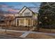 Charming two-story home featuring a modern farmhouse design with a black metal fence and manicured front yard at 684 S Vine St, Denver, CO 80209