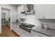 Modern kitchen showcases stainless steel range with white cabinets and grey countertops at 684 S Vine St, Denver, CO 80209