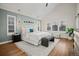 Vaulted main bedroom featuring a large bed, bench, and windows with neighborhood views at 684 S Vine St, Denver, CO 80209