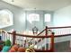 Bright foyer with white walls, wood trim, and chandelier highlighting the staircase with natural light shining through windows at 12578 Dexter Way, Thornton, CO 80241