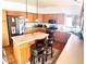 Well-equipped kitchen with stainless steel appliances, a tile island, and hardwood floors at 12578 Dexter Way, Thornton, CO 80241