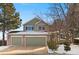 Two-story house with attached two-car garage and snow-covered yard at 9436 Wickerdale Ct, Highlands Ranch, CO 80130