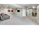 Finished basement with a couch, entertainment space, and an exercise bike area at 7835 Canvasback Cir, Littleton, CO 80125
